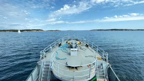 Tug-boat-travelling-across-narrow-Finnish-archipelago-fairway-during-summer-day