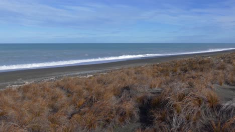 Panning-across-vast-ocean-and-desolate-landscape---Kaitorete-Spit,-New-Zealand