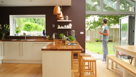 man working from home in a modern kitchen