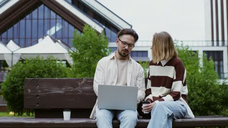 couple working on a laptop outdoors