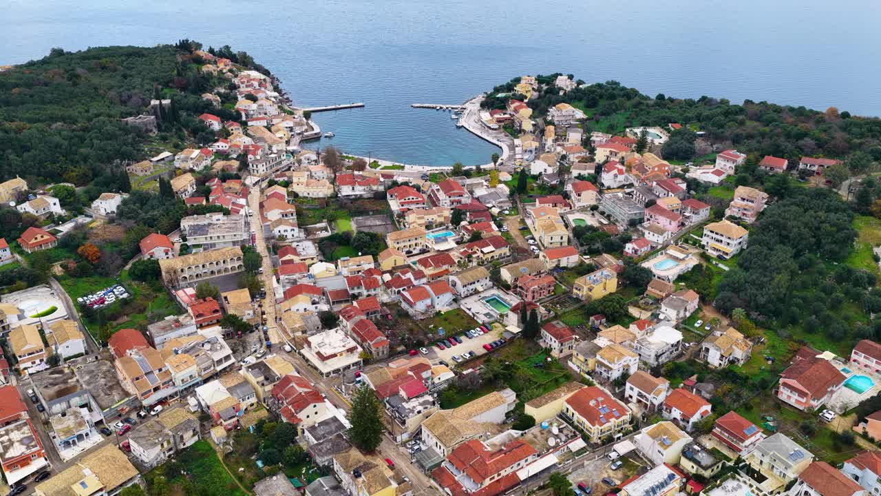 Aerial Drone View of Coastal Greek Village Kassiopi on Corfu Island with Red Roofs and Harbor