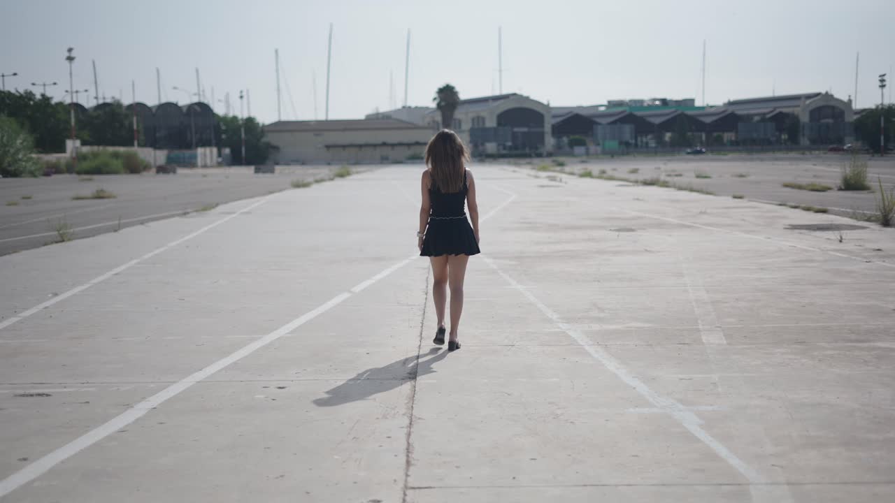 Woman Walking in an Empty Parking Lot