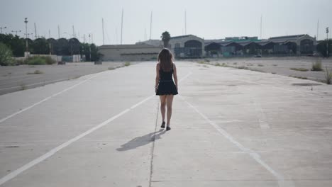 woman walking in an empty parking lot