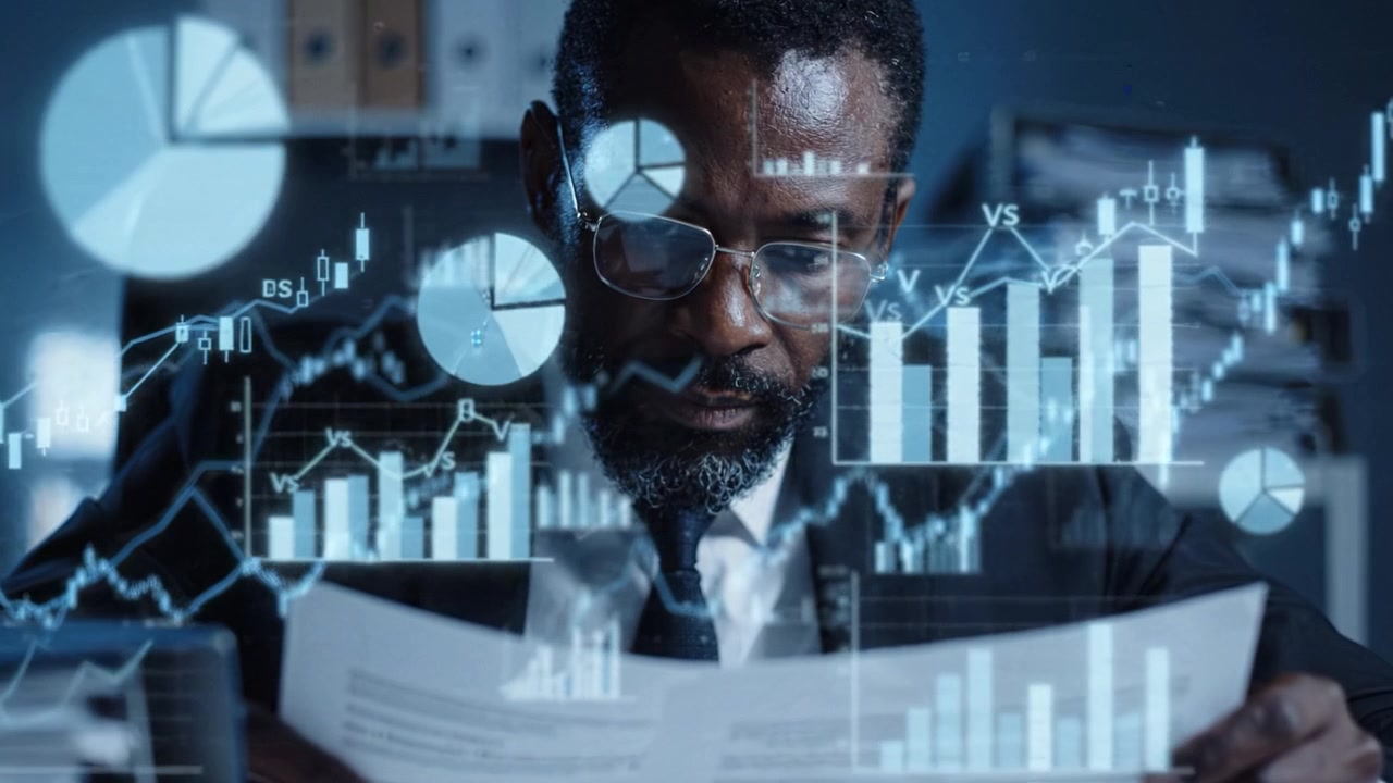 Focused Businessman Analyzing Financial Reports with Digital Graphs and Charts in a Modern Office Setting, Representing Data-Driven Decision Making.
