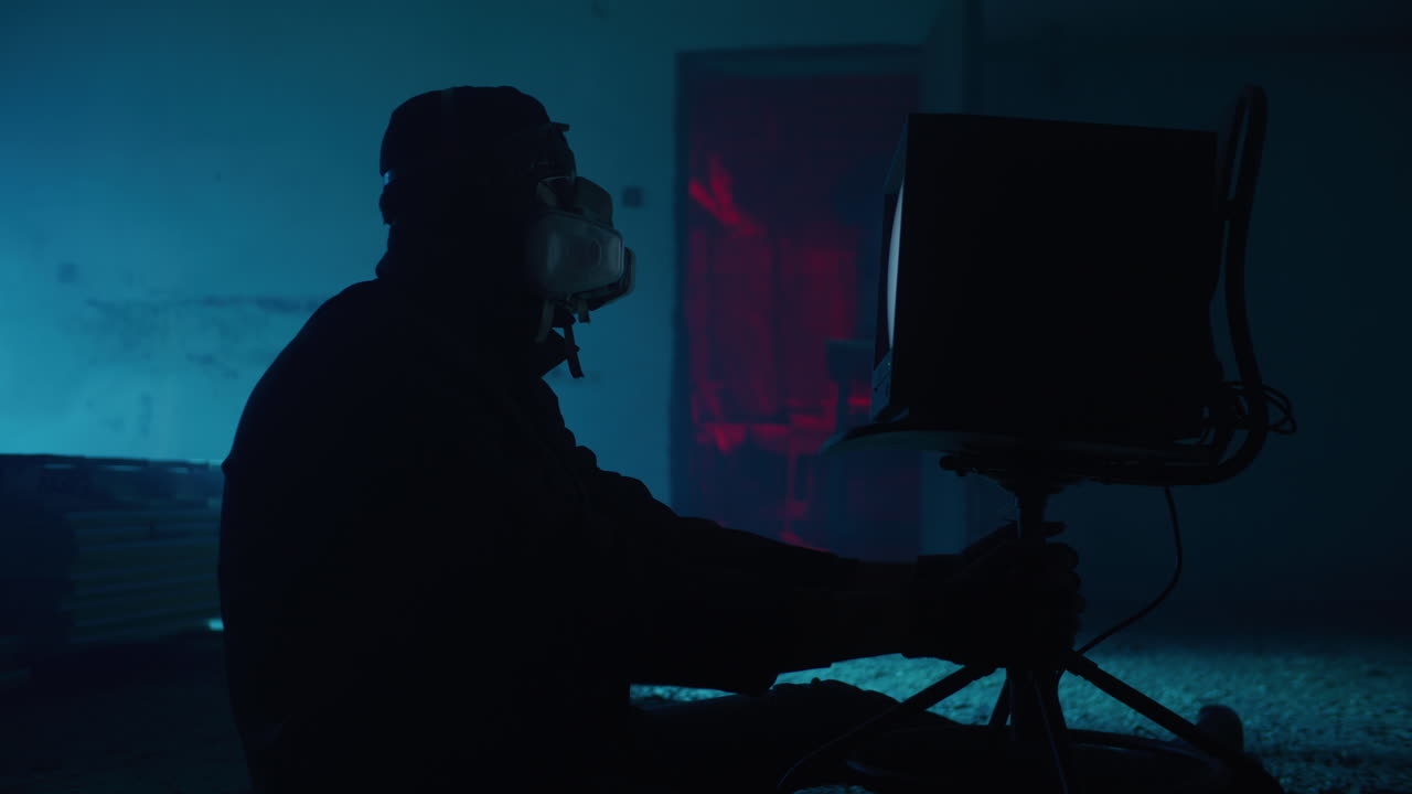 Silhouette of a Person in VR Headset and Gas Mask in a Dark Room