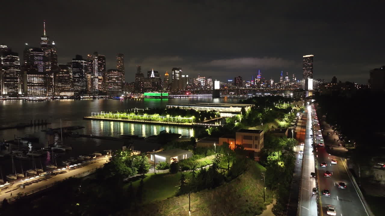 Aerial view of Brooklyn Bridge Park and Midtown Manhattan. Shot along The East River at night.