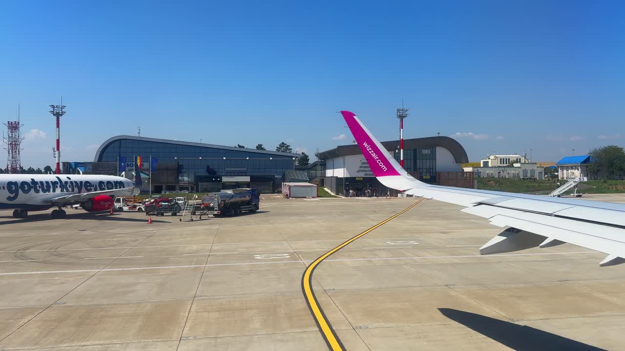 Plane window view takeoff Suceava Airport in Romania, fly airplane wing view