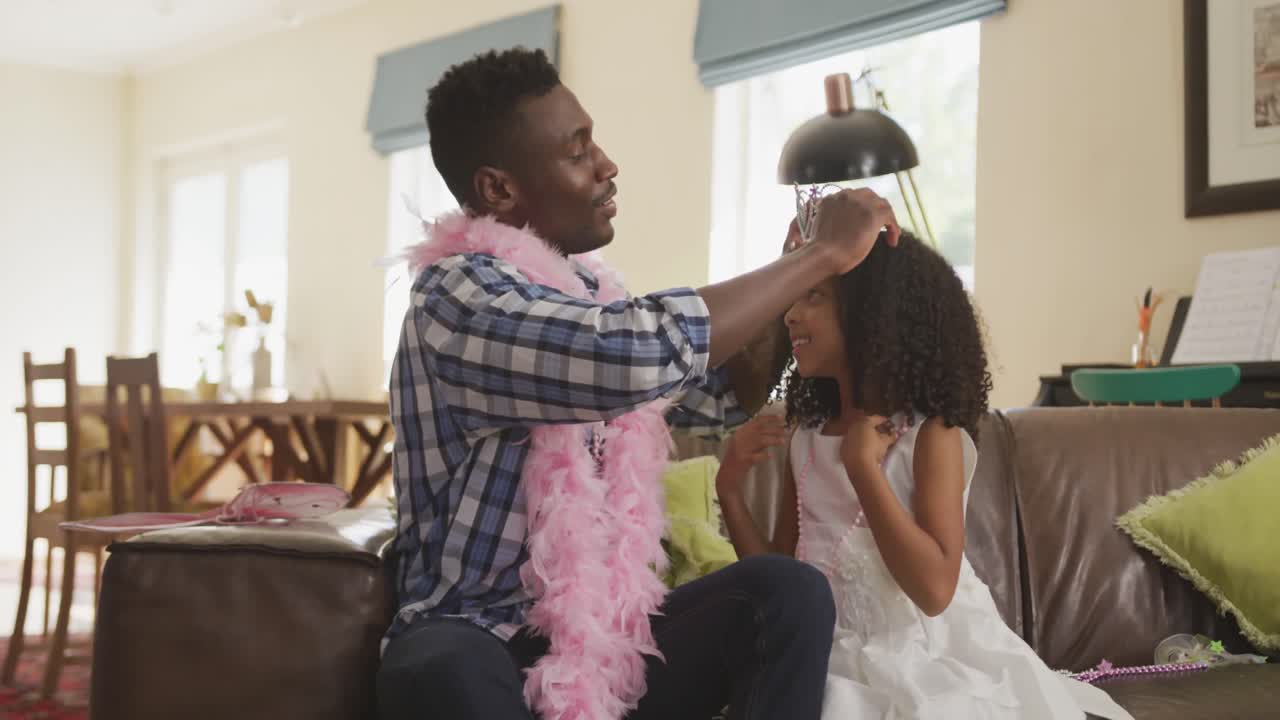 African american father and daughter disguising each other