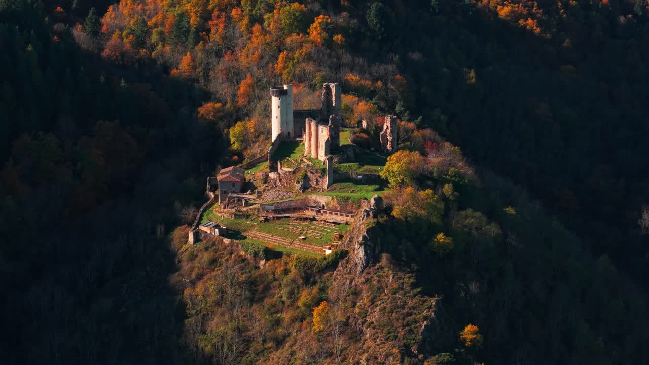 aerial shot zoomed on the Rochebaron Castle near Bas en Basset during fall season, Haute Loire departement, Auvergne Rhone Alpes region, France