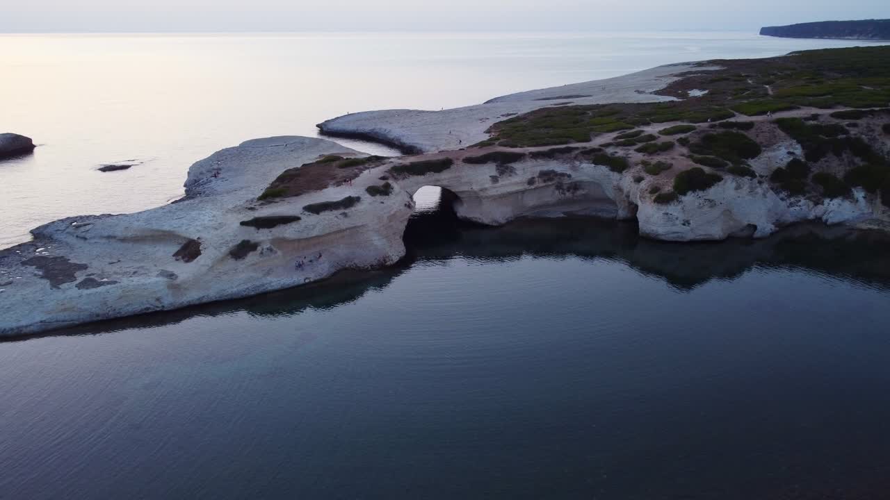 Famous Sardinian arch coast rock formation, S'Archittu, aerial view, sunset