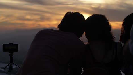 young couple watching sunset