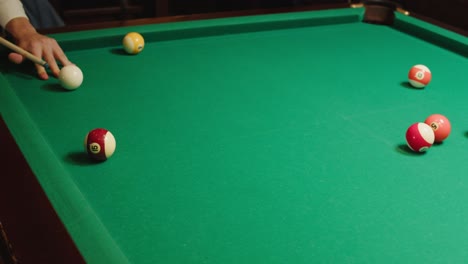 playing american billiard poule close-up. colorful balls on green billiards table .billiard balls with numbers on a pool table. billiards team sport. high quality 4k footage