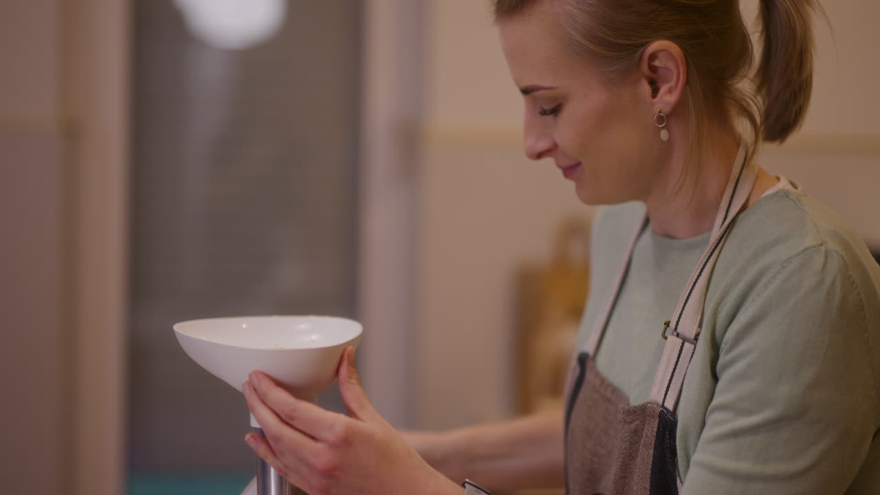 mujer feliz trabajando en la cocina moliendo carne