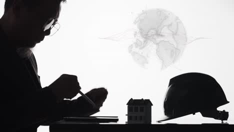 an engineer or architect designing a home for a global market - silhouette with a rotating graphic of the earth