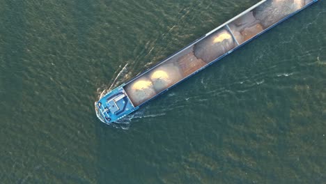 top-down drone view about river drone dordrecht cargo ship with scattered ground cargo at mid oude maas distributary, zuid-holland, netherlands