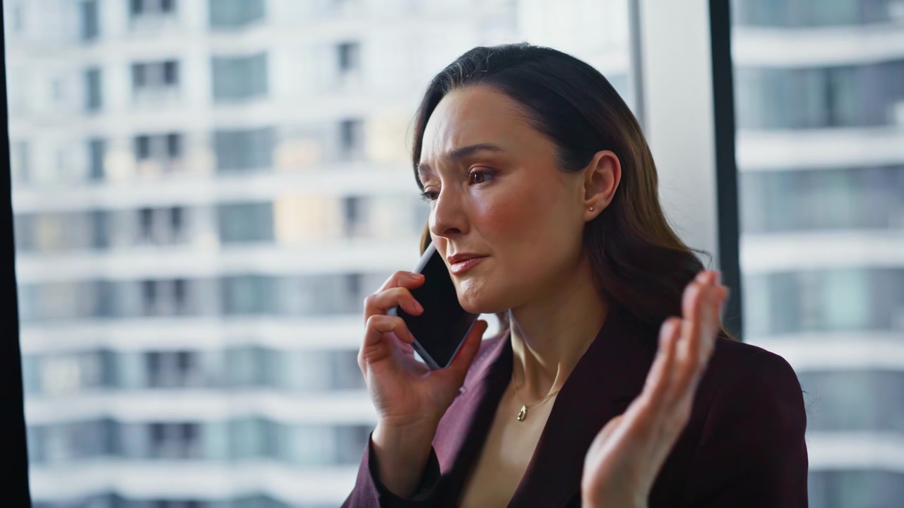 Wealthy business lady calling mobile phone standing office gesturing closeup