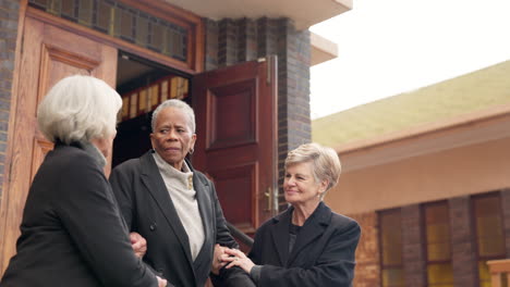 Funeral,-church-and-senior-women-walking-helping