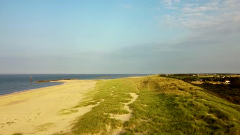 eccles sandy sea beach with scenic grassland at norfolk, england - dolly shot