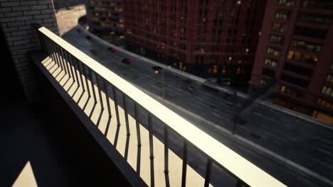 a view from a balcony overlooking a city street at sunset