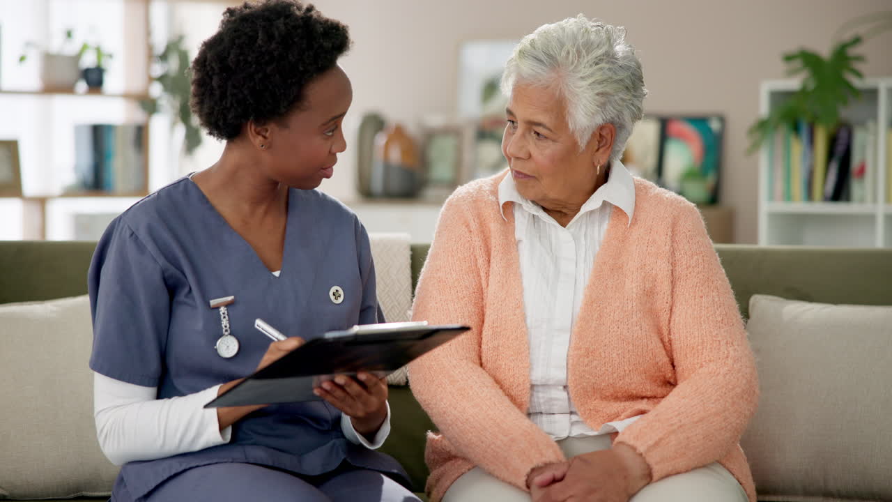 Home healthcare visit between nurse and senior woman