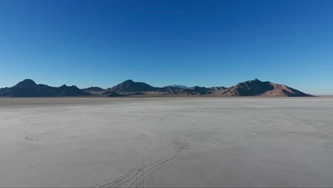 flying over the bonneville salt flats in northwestern utah reveal white salt and tire tracks