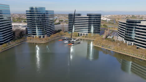 Business-offices-and-the-Oracle-Team-Trimaran-racing-yacht---aerial-approach