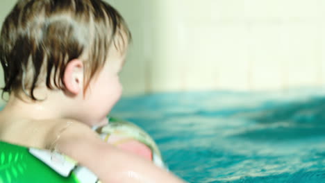 Back-view-of-a-kid-swimming-in-rubber-ring