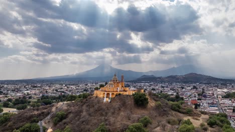 aerial shot showcases a stunning hilltop church with striking golden domes and twin spires, exuding an air of historical reverence and architectural splendor in mexico