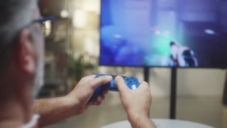 man playing a video game with a controller on a large tv