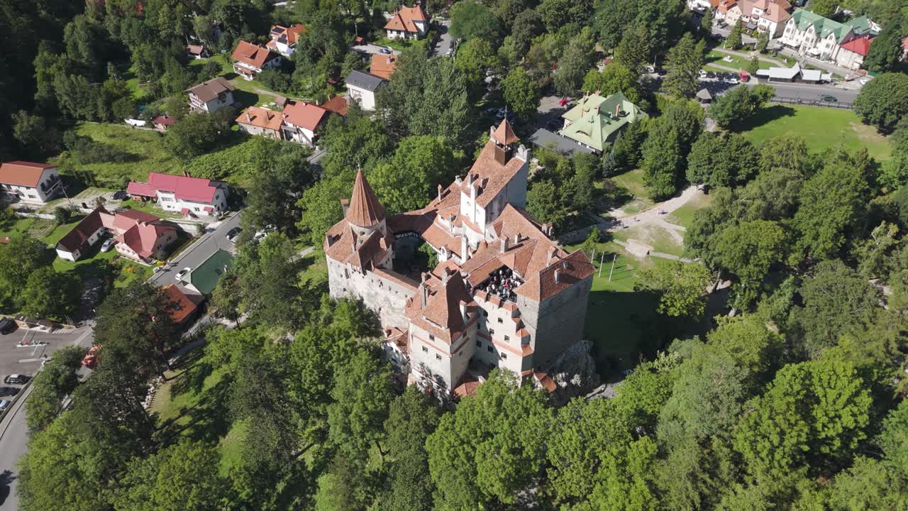 Top-down drone view of Bran Castle, showcasing its structure, courtyard, and surrounding landscape
