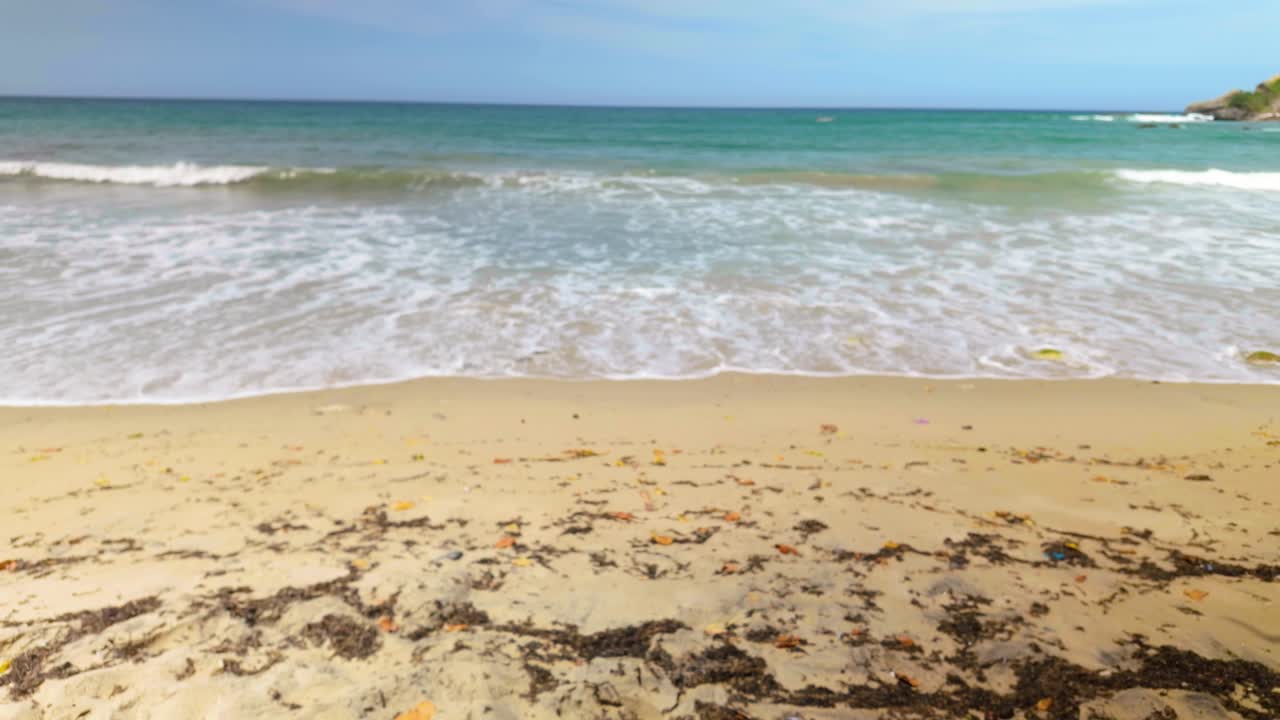 Beach with clear water and gentle waves crashing on a sandy shore, Playa Urama