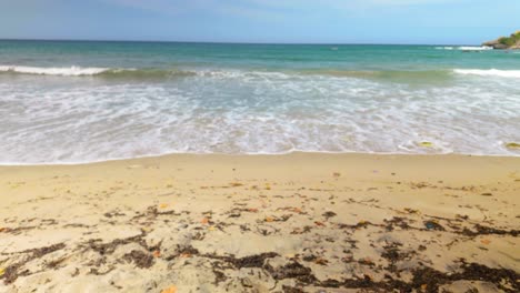 beach with clear water and gentle waves crashing on a sandy shore, playa urama