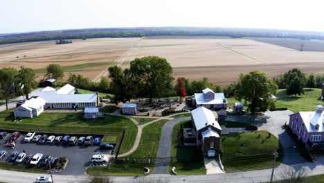 a unique view of pink homes in rural missouri, contrasting brightly against the natural surroundings of fields and trees, showcasing charm and individuality in a peaceful countryside setting.