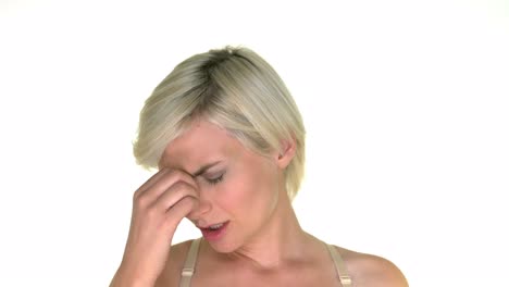 a blond woman is experiencing pain due to sinus pain