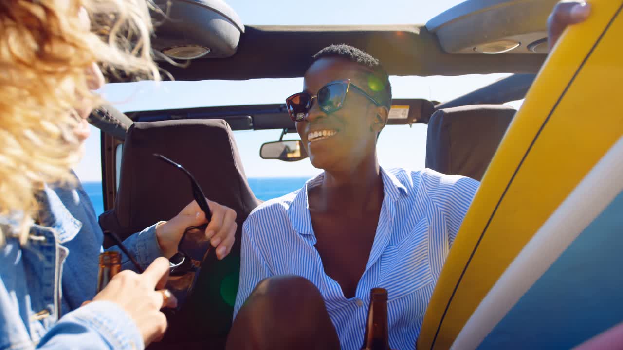 Female friends interacting with each in the car 4k