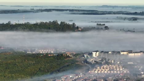 aerial view over puerto montt neighbourhoods with morning mist