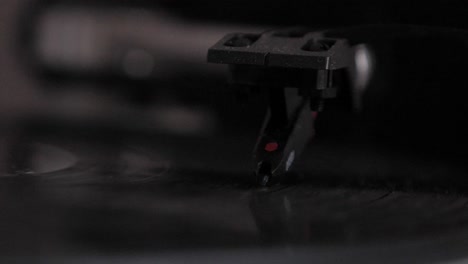 Slow-motion-macro-shot-of-turntable-needle-on-spinning-vinyl-turntable