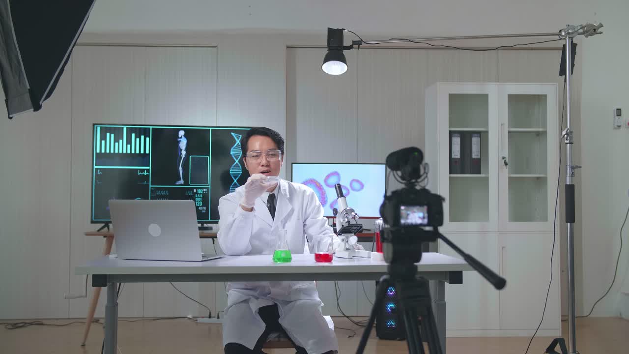 Asian Scientist Man Holding Petri Dish And Talking To Camera With Professional Lighting