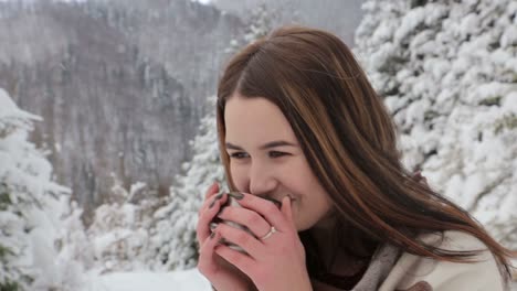 young pretty girl drinks hot tea on the date in winter forest young pretty girl drinks hot tea on the date in winter forest