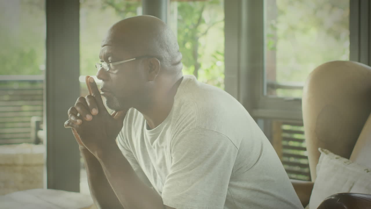 Animation of glowing lights of water over a sad senior african american man