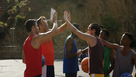 basketball players giving high five to each other