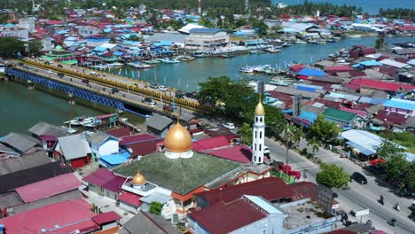 masjid jami addin mosque near jembatan dua manggar bridge across river in kalimantan timur, indonesia