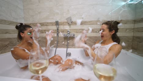 two women enjoying a fun bath party