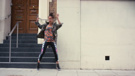 Contemporary-funky-mixed-race-woman-street-dancer-dancing-freestyle-in-the-city