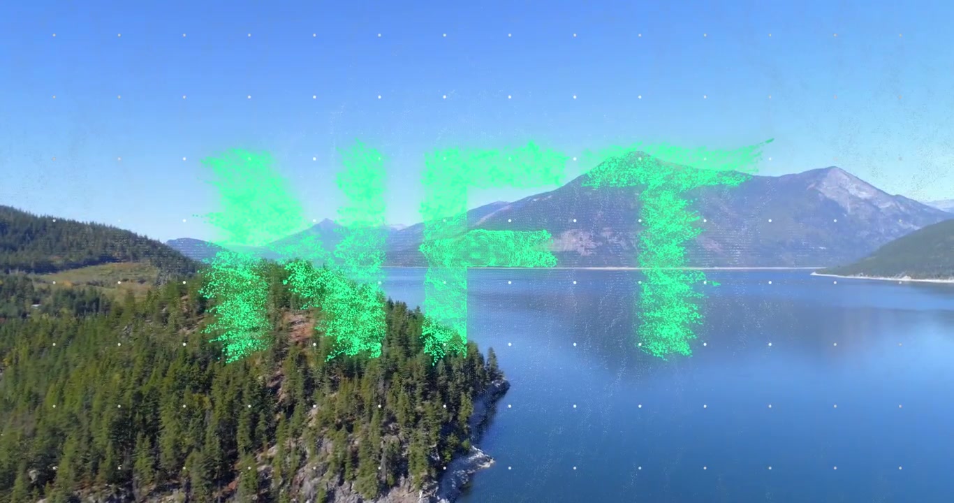 Animation af NFT-tekstbanner over luftfoto af skov, hav og bjerge.