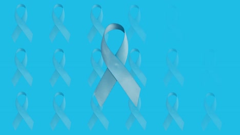 Animation-of-blue-cancer-awareness-ribbon-over-repeated-ribbons-on-blue-background