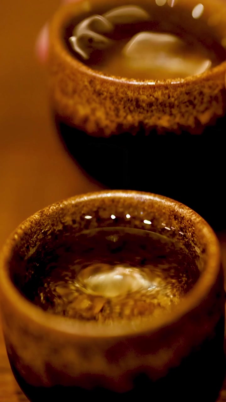 Close-up Cairan Berputar dalam Cangkir Sake Tradisional Jepang