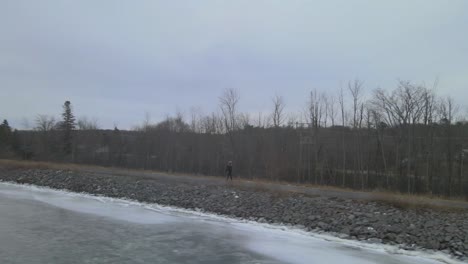 aerial drone following a young woman on a winter day