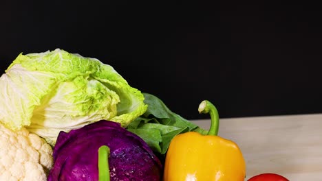 assorted vegetables arranged against a black background