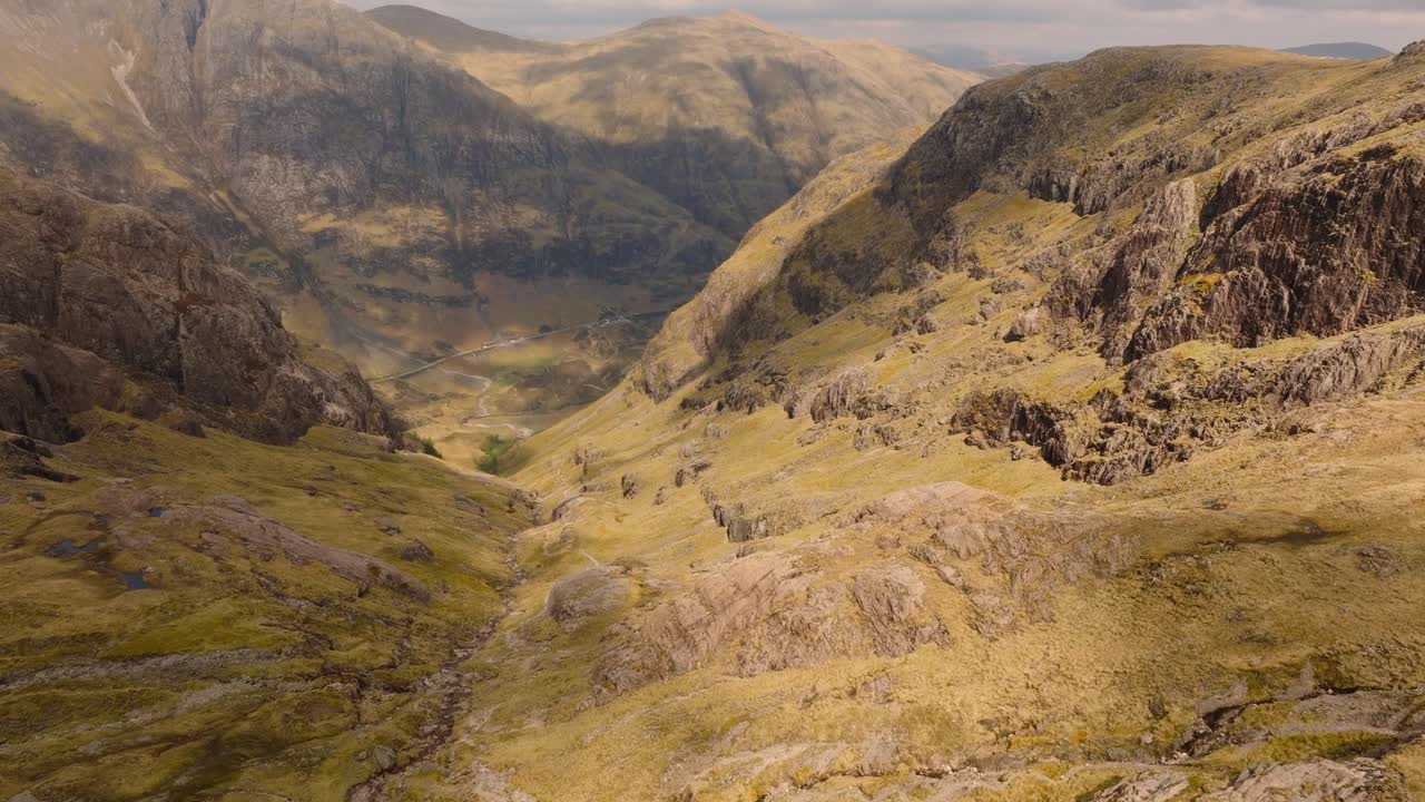 Aerial drone footage of Bidean Nam Bian, the highest mountain in Glencoe, Scotland. Sweeping views of peaks, deep valleys, and dramatic Highland scenery